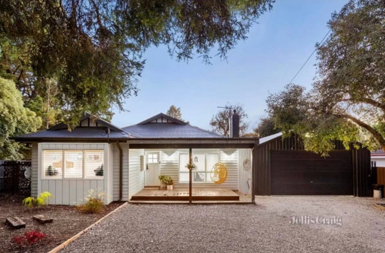 Renovated weatherboard facade with landscaped gardens