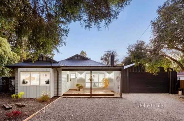 Renovated weatherboard facade with landscaped gardens
